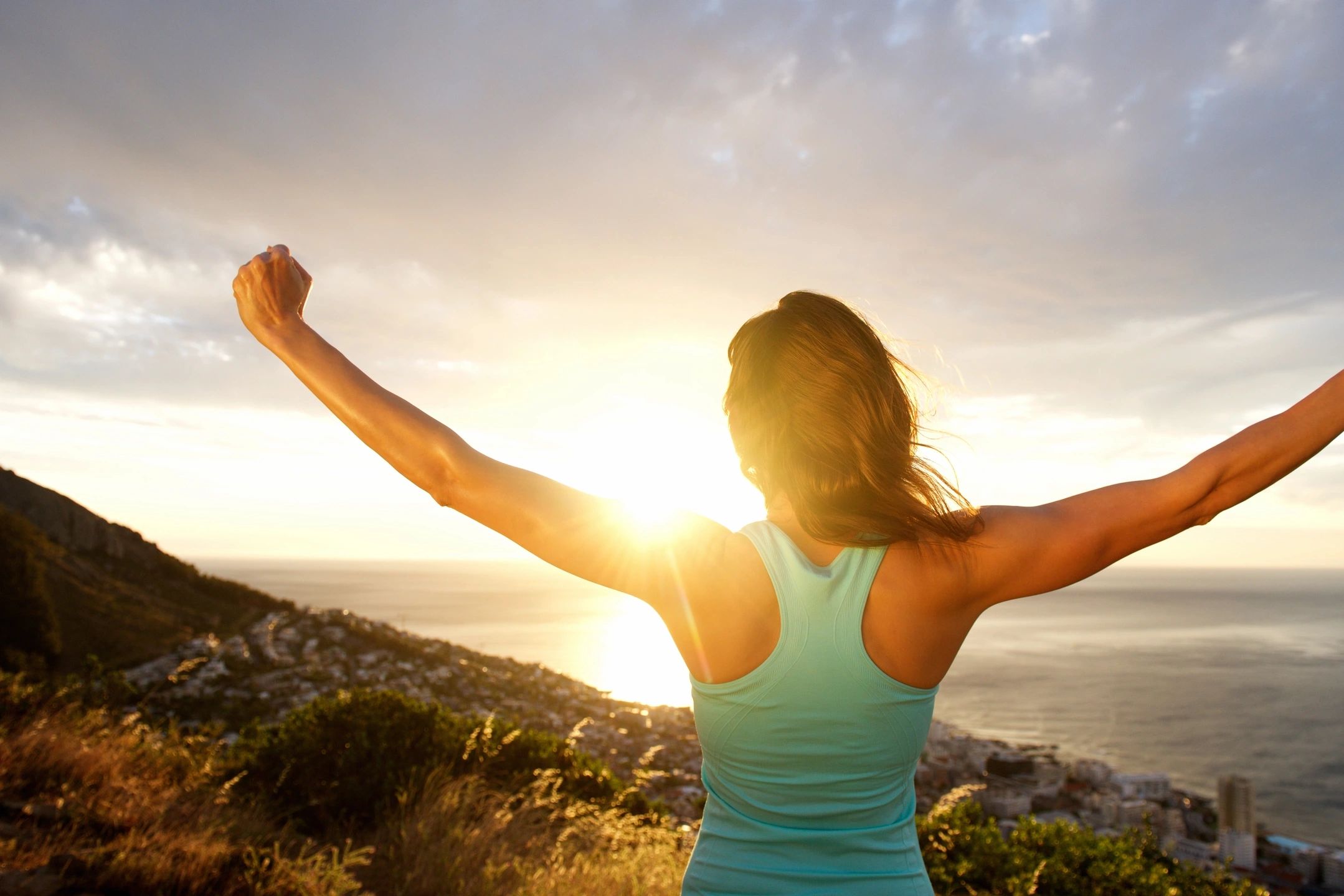Woman celebrating improved mental health after finding insurance-covered therapy in Davis, California.